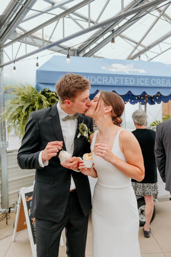 Bride and Groom kissing and eating ice cream