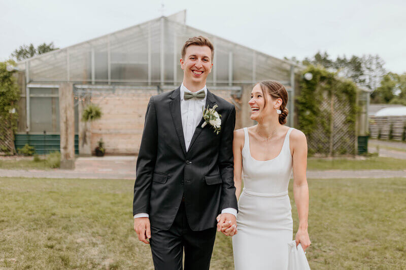 Bride and Groom smiling outside The Atrium, an outdoor wedding venue in Wisconsin