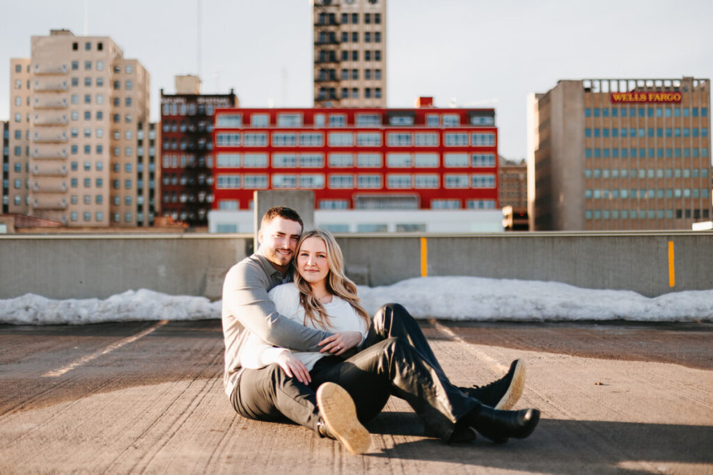 Couple hugging at parking ramp engagement session in Duluth, MN