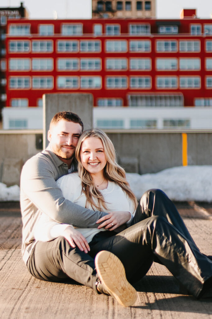 Couple hugging at parking ramp city engagement session in Duluth, MN