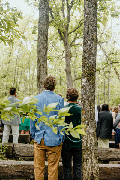 Guests standing for the bride during an outdoor wedding ceremony at The Atrium in Solon Springs, Wisconsin